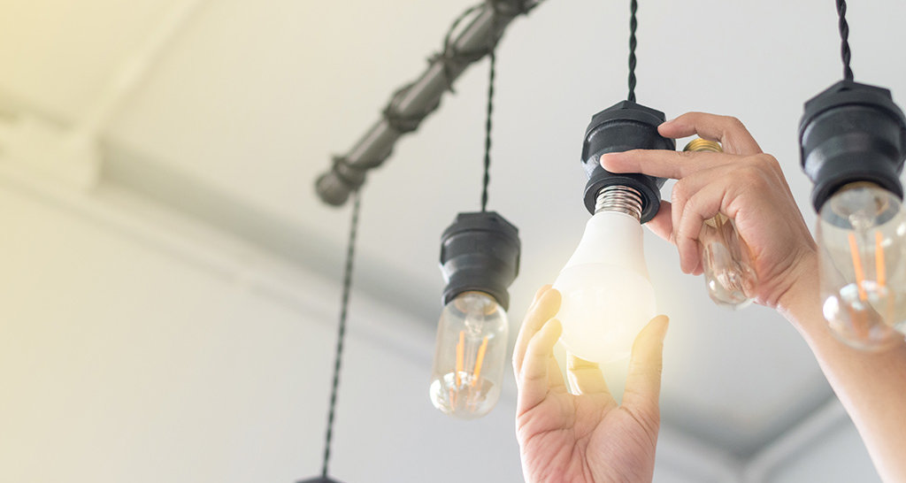 Energy scan in underprivileged families Man repairs lamp
