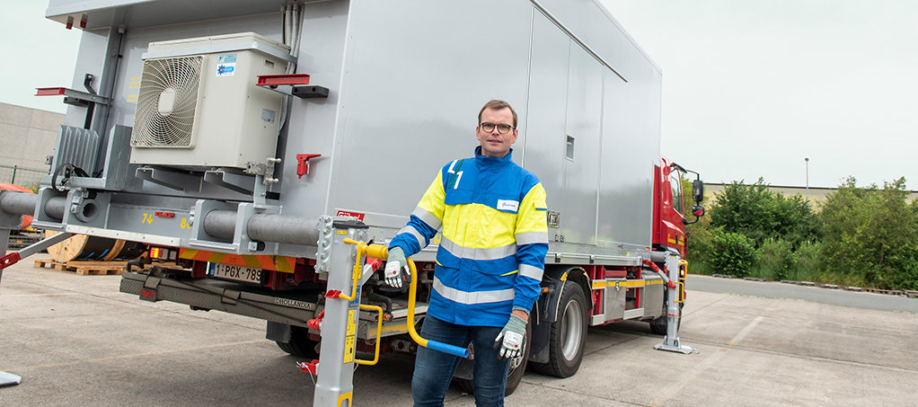 Technician stands in front of the mobile electric rescue station