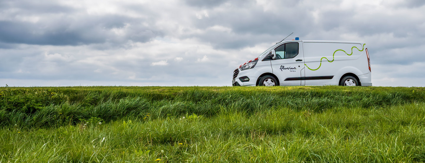 A Fluvius employee charges his electric car